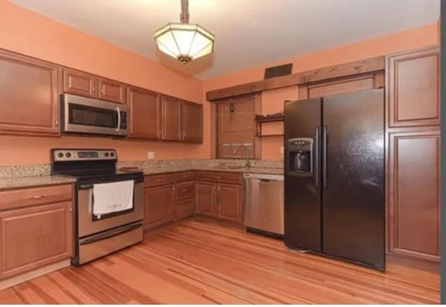 75 William St, Worcester, MA 01609 - kitchen with light wood-style floors, pendant lighting, a sink, and stainless steel appliances