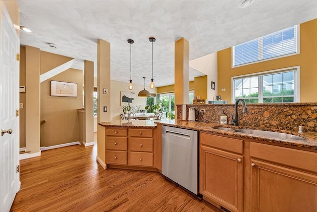 14 Ship Ave Unit 1, Medford, MA 02155 - kitchen featuring dishwasher, a sink, stone countertops, and light wood-type flooring