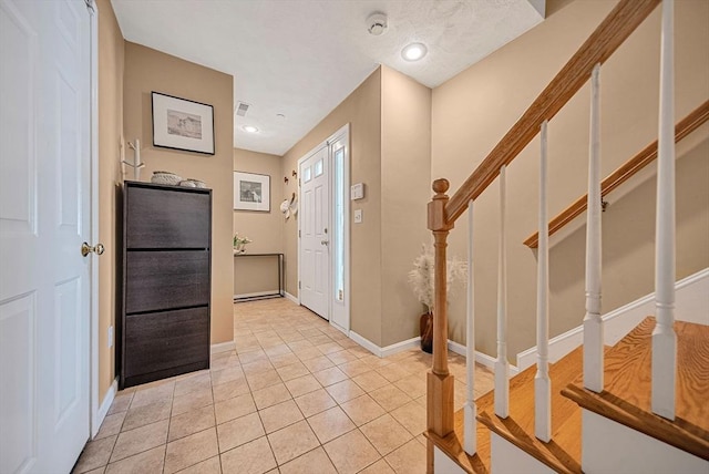 14 Ship Ave Unit 1, Medford, MA 02155 - foyer featuring stairway, baseboards, and light tile patterned floors