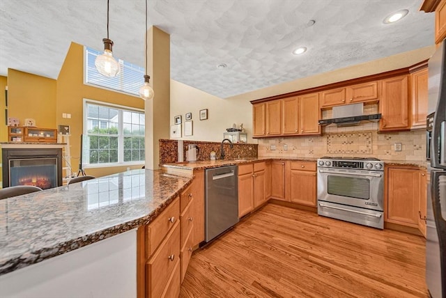 14 Ship Ave Unit 1, Medford, MA 02155 - kitchen with stainless steel appliances, under cabinet range hood, backsplash, light wood-type flooring, and recessed lighting