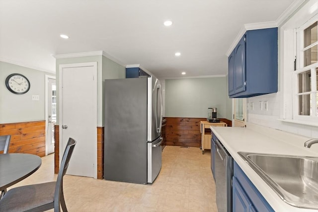 kitchen featuring light countertops, blue cabinetry, appliances with stainless steel finishes, and a sink