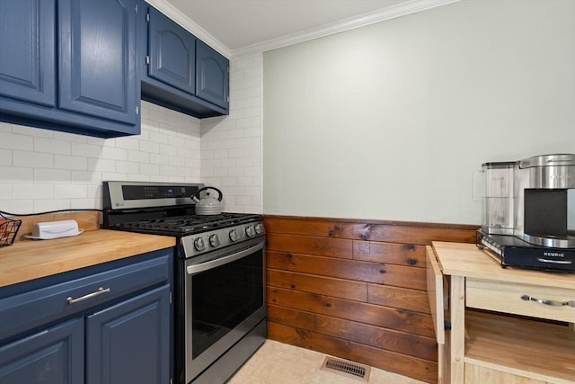kitchen with blue cabinets, gas stove, wooden counters, and ornamental molding