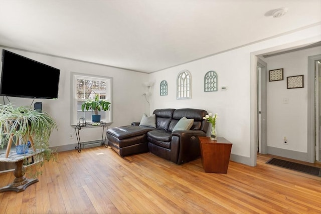 living room with baseboards and light wood-type flooring