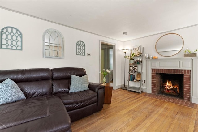 living room featuring a fireplace and light wood-style flooring