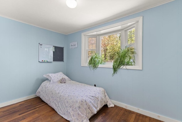 bedroom featuring crown molding, baseboards, and dark wood-style floors