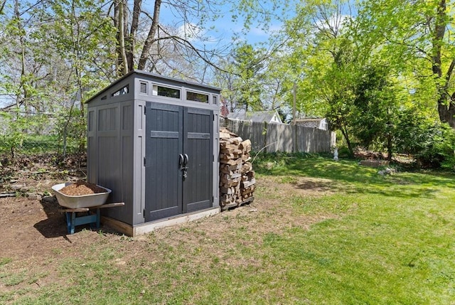 view of shed featuring fence