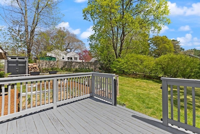 wooden deck featuring a yard