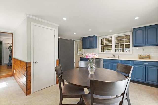 dining space with recessed lighting and ornamental molding