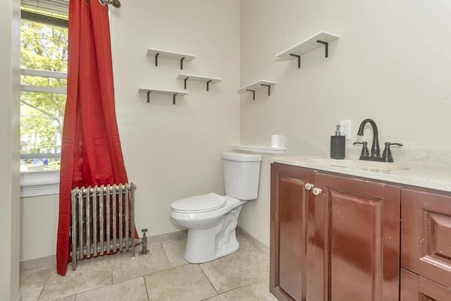 51 Stratford Ter, Springfield, MA 01108 - bathroom with radiator, toilet, vanity, tile patterned floors, and baseboards
