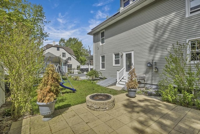 51 Stratford Ter, Springfield, MA 01108 - rear view of property featuring a patio, an outdoor fire pit, entry steps, and a lawn