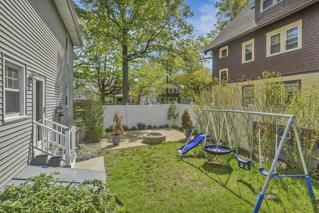 51 Stratford Ter, Springfield, MA 01108 - view of yard featuring a playground, an outdoor fire pit, and entry steps