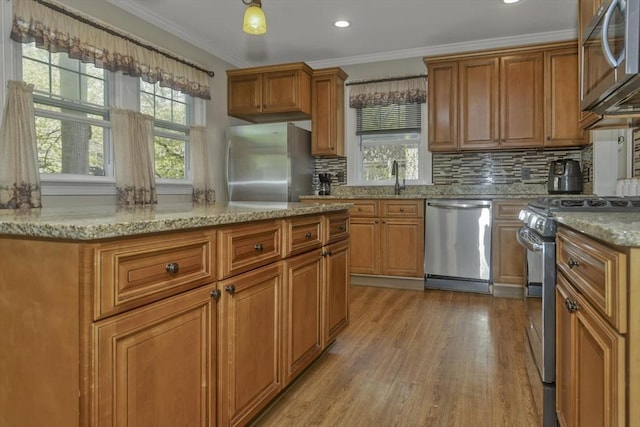 51 Stratford Ter, Springfield, MA 01108 - kitchen with stainless steel appliances, tasteful backsplash, wood finished floors, brown cabinets, and crown molding