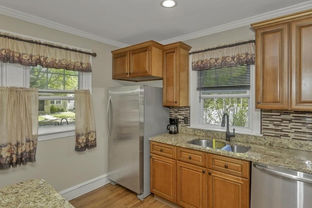 51 Stratford Ter, Springfield, MA 01108 - kitchen featuring appliances with stainless steel finishes, a sink, healthy amount of natural light, brown cabinets, and crown molding