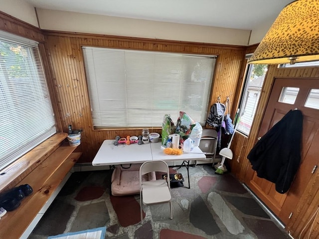 dining room with wooden walls