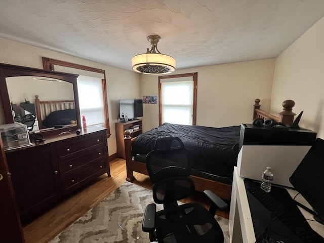 bedroom featuring light wood-style floors and a textured ceiling