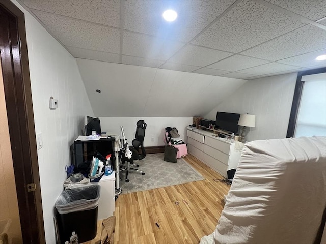 office area with lofted ceiling, a drop ceiling, and light wood-style floors