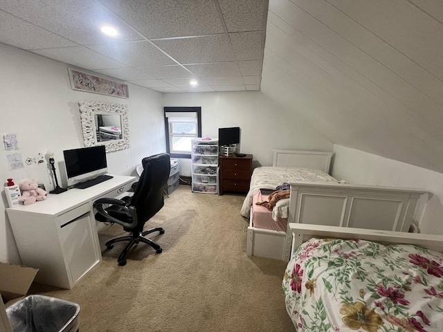 bedroom featuring light carpet, vaulted ceiling, and a drop ceiling