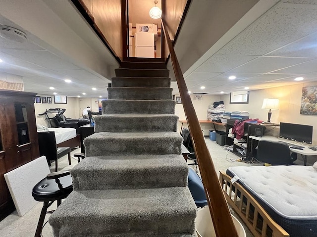 stairs featuring a drop ceiling, carpet, and recessed lighting