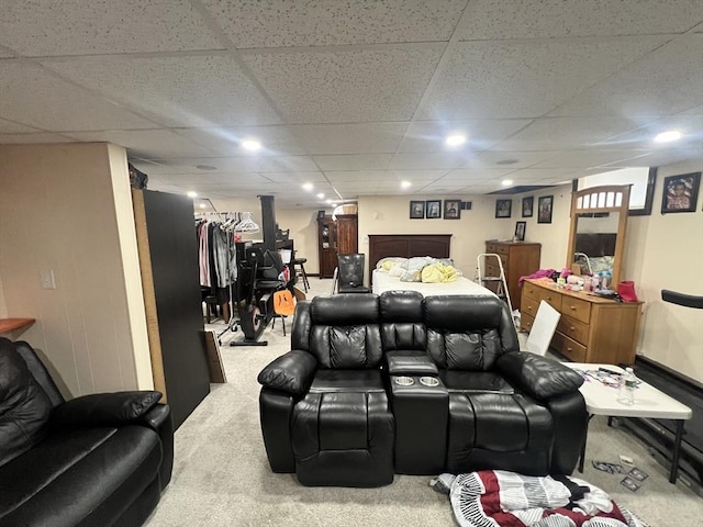 home theater room featuring carpet floors and a drop ceiling