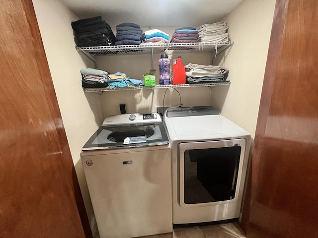 clothes washing area featuring laundry area and separate washer and dryer