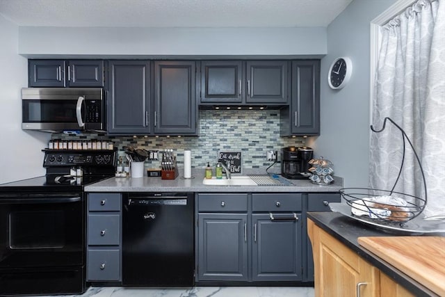 1102 Foxwood Cir Unit 1102, Peabody, MA 01960 - kitchen featuring black appliances, backsplash, and light countertops