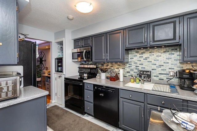 1102 Foxwood Cir Unit 1102, Peabody, MA 01960 - kitchen with black appliances, light countertops, a sink, backsplash, and a textured ceiling