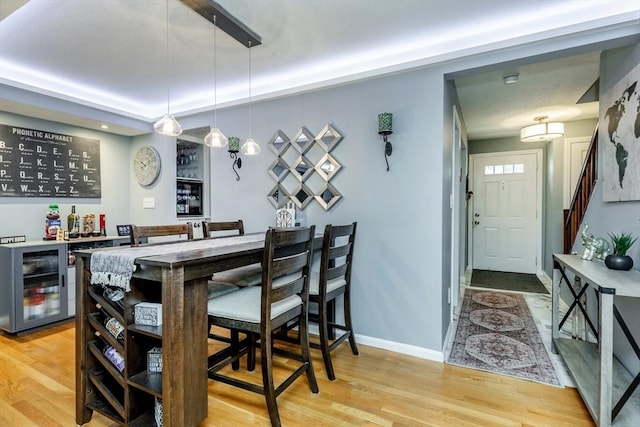 1102 Foxwood Cir Unit 1102, Peabody, MA 01960 - indoor dry bar featuring wine cooler, light wood-type flooring, baseboards, and stairs