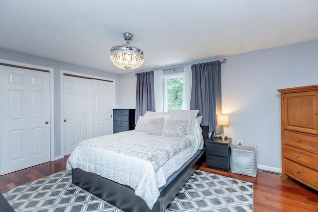 1102 Foxwood Cir Unit 1102, Peabody, MA 01960 - bedroom featuring wood finished floors, baseboards, and a chandelier
