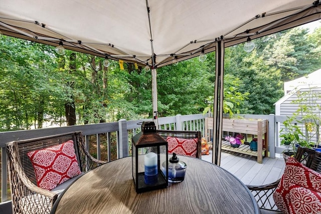 1102 Foxwood Cir Unit 1102, Peabody, MA 01960 - wooden deck with outdoor dining space and view of scattered trees