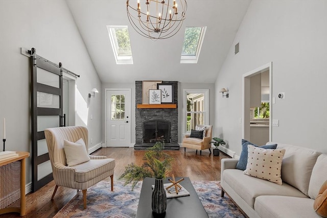 6 Candida Ln, Acton, MA 01720 - living room with a barn door, high vaulted ceiling, healthy amount of natural light, wood finished floors, and a stone fireplace