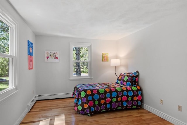 6 Candida Ln, Acton, MA 01720 - bedroom with wood finished floors and a baseboard radiator
