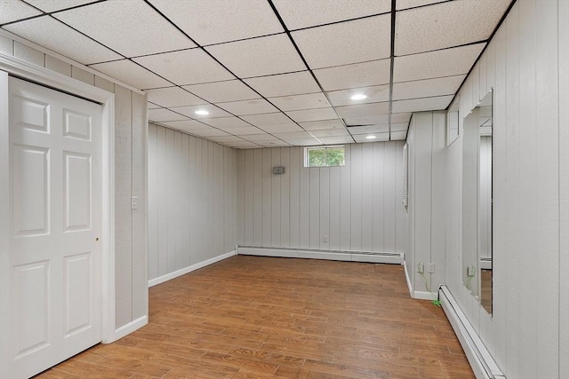 6 Candida Ln, Acton, MA 01720 - below grade area with baseboard heating, light wood-style flooring, recessed lighting, wooden walls, and a paneled ceiling
