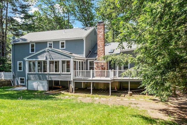 6 Candida Ln, Acton, MA 01720 - rear view of house featuring a sunroom, a chimney, a wooden deck, a yard, and a shingled roof