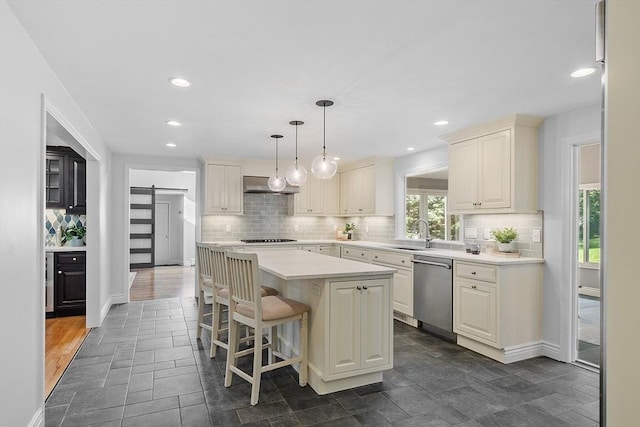 6 Candida Ln, Acton, MA 01720 - kitchen with dishwasher, a barn door, a kitchen island, light countertops, and backsplash