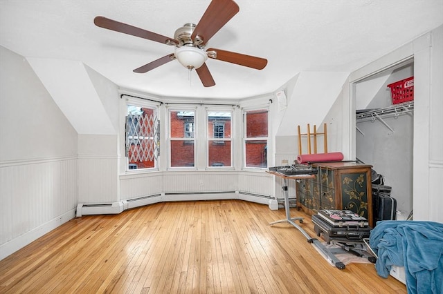 additional living space with wood-type flooring and ceiling fan