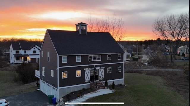 exterior space with a garage and a shingled roof