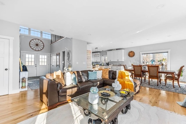 living room featuring light wood-type flooring and french doors