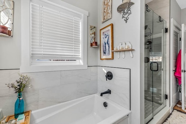 full bath with a stall shower and a bath
