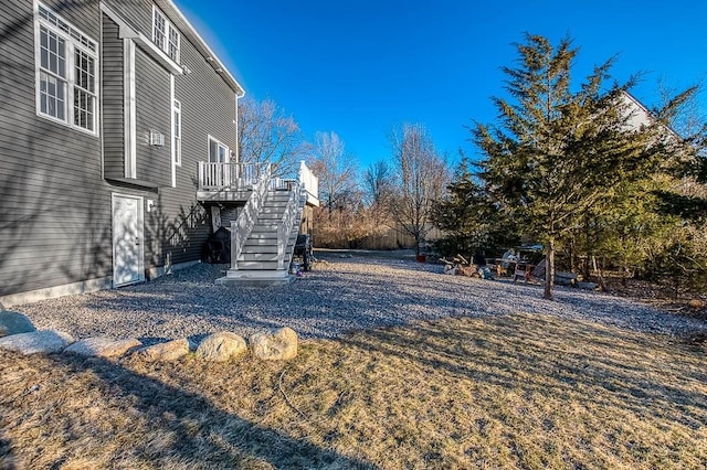 view of yard featuring stairway and a wooden deck
