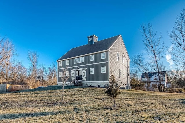 back of property featuring a yard and central AC unit