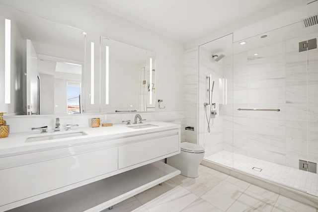 bathroom with vanity, a shower with shower door, and toilet