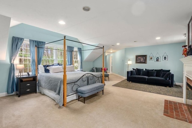 bedroom featuring recessed lighting, a fireplace with flush hearth, carpet, and baseboards