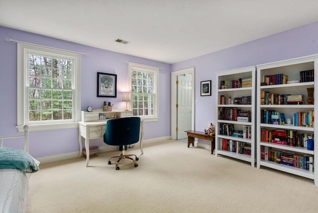 carpeted office featuring visible vents and baseboards