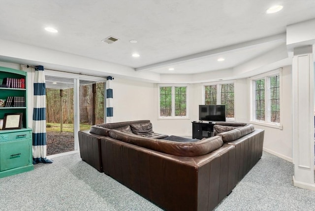living room with a healthy amount of sunlight, carpet flooring, baseboards, and visible vents