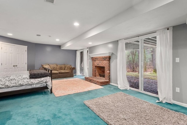unfurnished living room with recessed lighting, a brick fireplace, and carpet floors