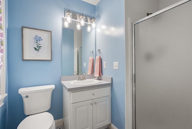 full bathroom with a shower stall, vanity, and toilet