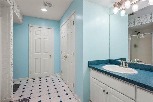 bathroom featuring tile patterned floors, vanity, visible vents, and a stall shower