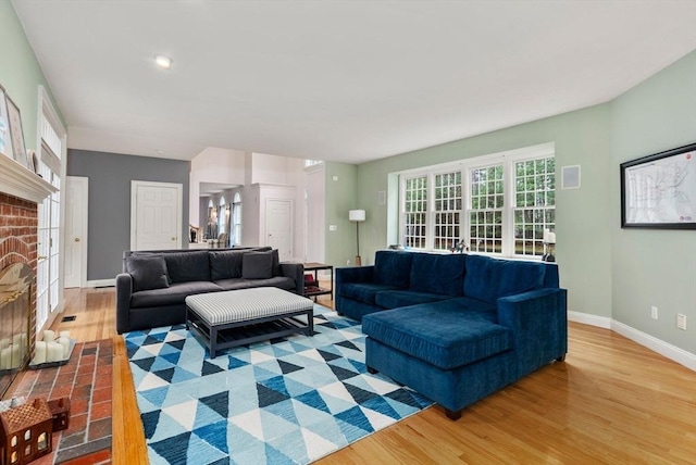 living area featuring baseboards and wood finished floors