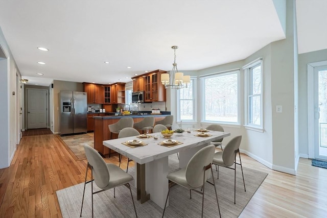 dining area featuring a notable chandelier, recessed lighting, baseboards, and light wood finished floors