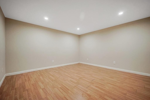 spare room with recessed lighting, baseboards, and light wood finished floors